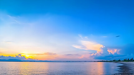 Coastal Sunset Scene With Brilliant Blue Sky And Golden Sunlight Reflecting On Calm Water