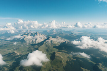 Fototapeta premium Aerial perspective of an impressive mountain range with sharp rock formations and low-hanging clouds. 