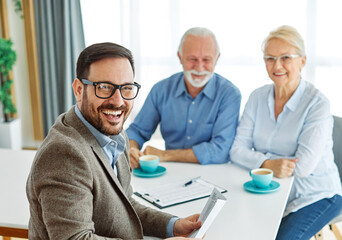 contract signing senior couple document investment business finance agent meeting agreement home...