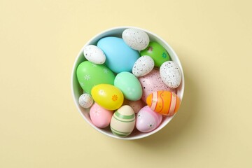 Happy Easter. Colorful eggs in a bowl on color background, space for text or advertising