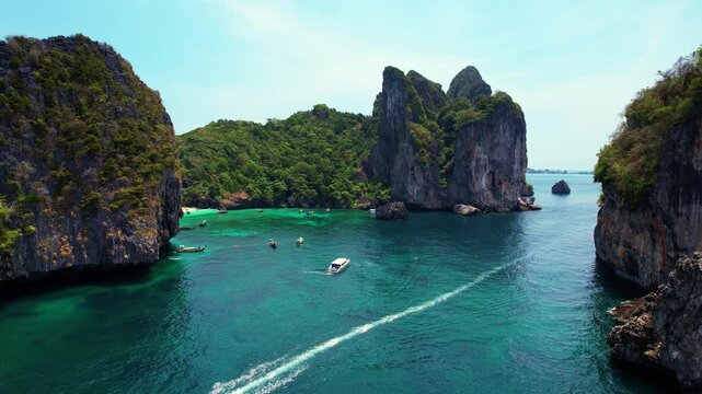 Turquoise lagoon with white coral sand Nui beach. Landscape koh Phi Phi Don island, Krabi, Thailand Aerial drone video.