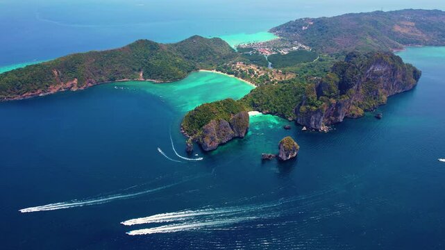 Landscape koh Phi Phi Don island, Krabi, Thailand. Aerial view paradise Nui beach, turquoise lagoon with white coral sand and palms on sunset time.