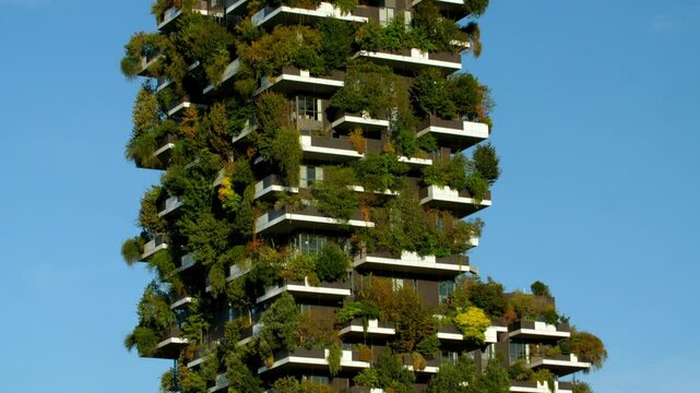 bosco verticale (vertical forest) residential towers close up view aerial drone architecture skyscraper building against blue sky