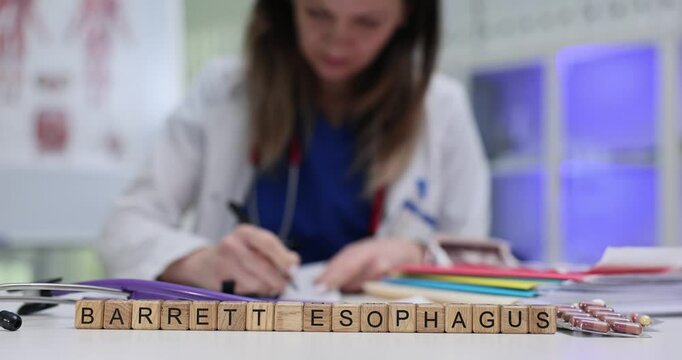 A healthcare professional is carefully examining data on Barrett Esophagus while diligently taking notes