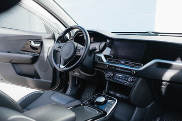Salon of a modern and youth electric car. Fast charging port.  Interior details.