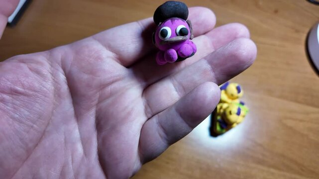 An angry red octopus, squid with tentacles swims in the blue sea with little white waves. octopus in hands.