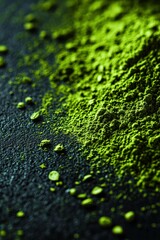 Moringa powder spread on a dark surface highlighting its vibrant color