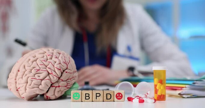 A visual representation of BPD research with a brain model, therapy tools, and medication information