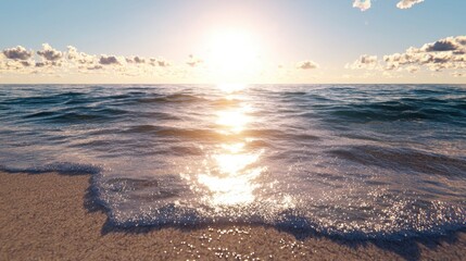 Obraz premium Golden sunlight glimmers on gentle ocean waves lapping at the shore, with a clear sky and wispy clouds forming a serene backdrop during late afternoon