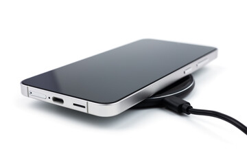 Mobile smart phone on wireless charging device on white background. smartphones connected to power...