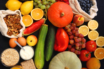 Various healthy fruits, vegetables and cereals on dark background. Top view.