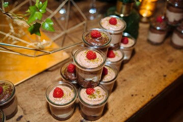 Chocolate mousse desserts with raspberries.