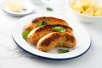 Homemade sausages served with potato salad