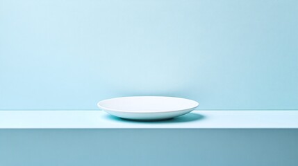 Minimalist Image of a White Ceramic Plate on a Soft Blue Surface, Perfect for Food Presentation and Display. Simple and clean design.