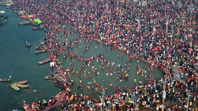 Aerial view of Huge crowd at Triveni Sangam in Prayagraj, India during Maha Kumbh. Kumbh Mela is the most important event, where millions of devotees, including Sadhu take a sacred holy dip in Ganga.