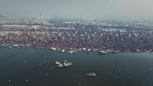 Aerial view of Huge crowd at Triveni Sangam in Prayagraj, India during Maha Kumbh. Kumbh Mela is the most important event, where millions of devotees, including Sadhu take a sacred holy dip in Ganga.