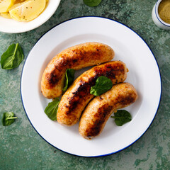 Homemade sausages served with potato salad