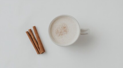 A mug of coffee with cinnamon sticks on top