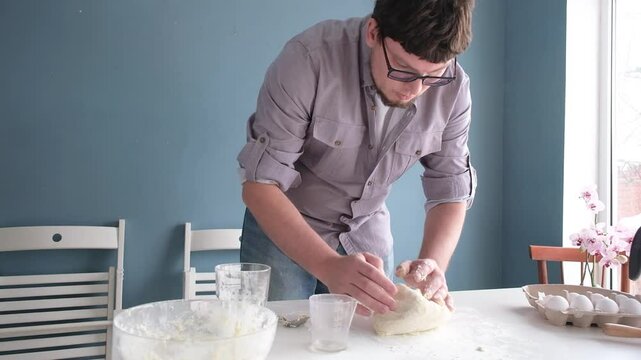 man kneading dough in the home kitchen