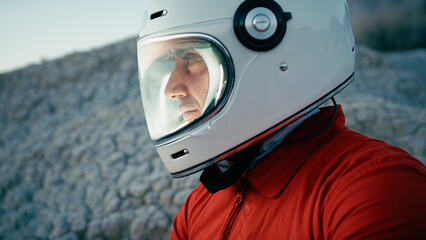 Astronaut With Helmet Looks Around And Opens Helmet Visor In New Planet