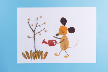 A creative artwork made from natural materials such as leaves, twigs, and seeds. Handmade nature composition featuring a mouse figure. Eco-friendly design concept for sustainability and creativity