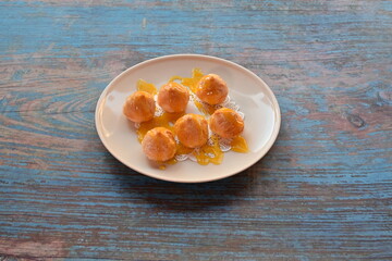 A plate of doughnuts with a yellow glaze