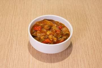A bowl of food with a lot of vegetables and meat