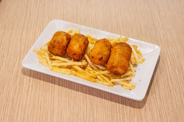 A plate of fried chicken and french fries