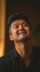 Fototapeta premium A Young Man Smiles Looking Upward With Hope