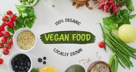 100 percent Organic Vegan Food Locally Grown text image over fresh vegetables and grains