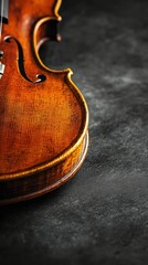 Elegant violin resting on a dark surface displaying fine craftsmanship
