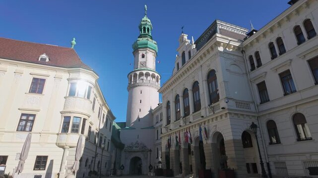 The iconic Fire Tower rises into the blue sky as the tallest building in Sopron, next to the town hall, on a sunny winter day in Hungary.