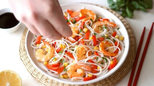 Rice noodles with shrimp, pepper and corn. Seafood. Asian cuisine.