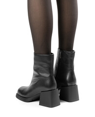 Women's shoes on a white background. Close up of a women's black leather chelsea boots on white background. Footwear for city, urban lifestyle or traveling. Concept of fashion, design and footwear.