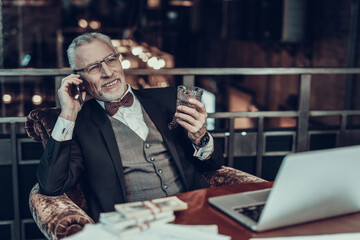 portrait of Old Businessman drinking brandy