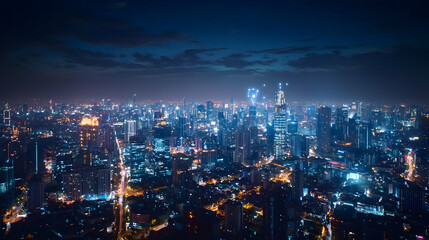 Aerial View of Illuminated City at Night with Blue Tones and Dense Skyscrapers