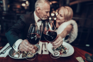 smiling Woman drink wine with Businessman