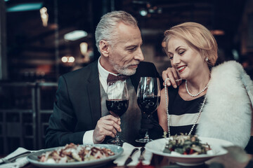 smiling Woman drink wine with Businessman