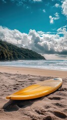 Obraz premium Yellow Surfboard on Sandy Beach Under Cloudy Sky