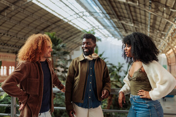 Group of young people talking and smiling in a building