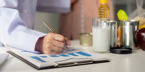 Nutrition documentation and assessment. Nutritionist documenting dietary progress for a client.