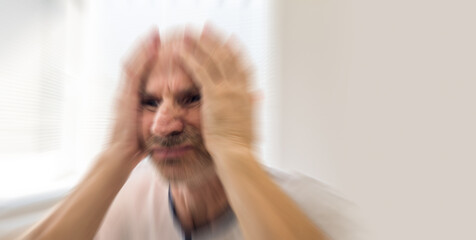 Mentally sick senior is having seizure of the anxiety. Blurry mental health concept.