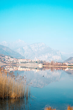 Tranquil Lago di Annone with Civate and Mountains Reflected in Water