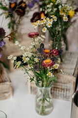 Rustic wildflower bouquet in a glass vase.