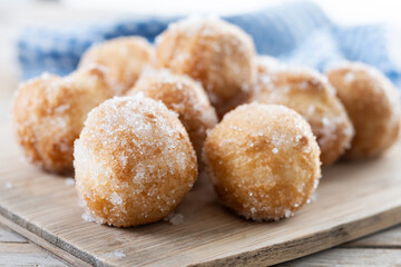 Traditional Carnival fritters or buñuelos de viento on wooden table. cLOSE UP