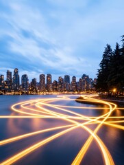 Obraz premium A serene cityscape at dusk with illuminated water trails and a skyline of modern buildings, creating a harmonious blend of nature and urban life.