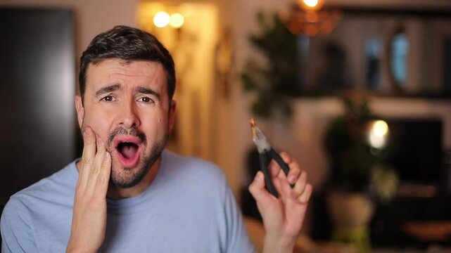Man removing his own tooth