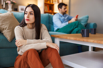 Couple distant and angry after having a fight at home