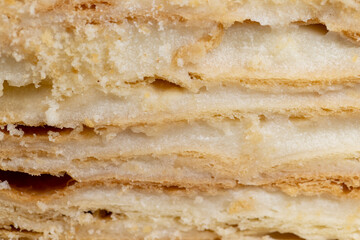 layered cake with white sweet cream on a board