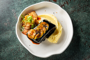 A gourmet dish featuring rolled eggplant stuffed with shrimp, served on creamy mashed potatoes and accompanied by spicy kimchi, garnished with green onions.